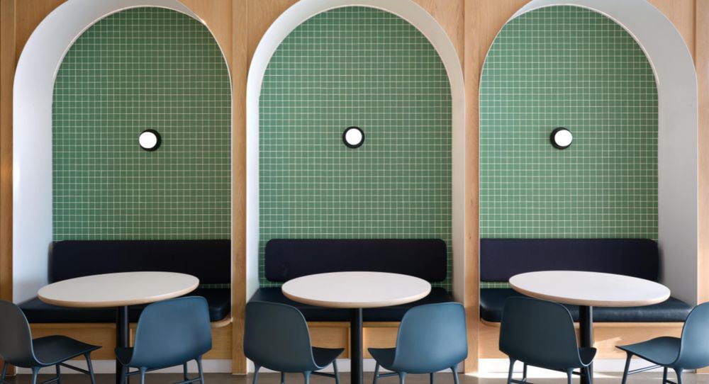 Three green-tiled arched booths framed in white oak at Honest Mary's