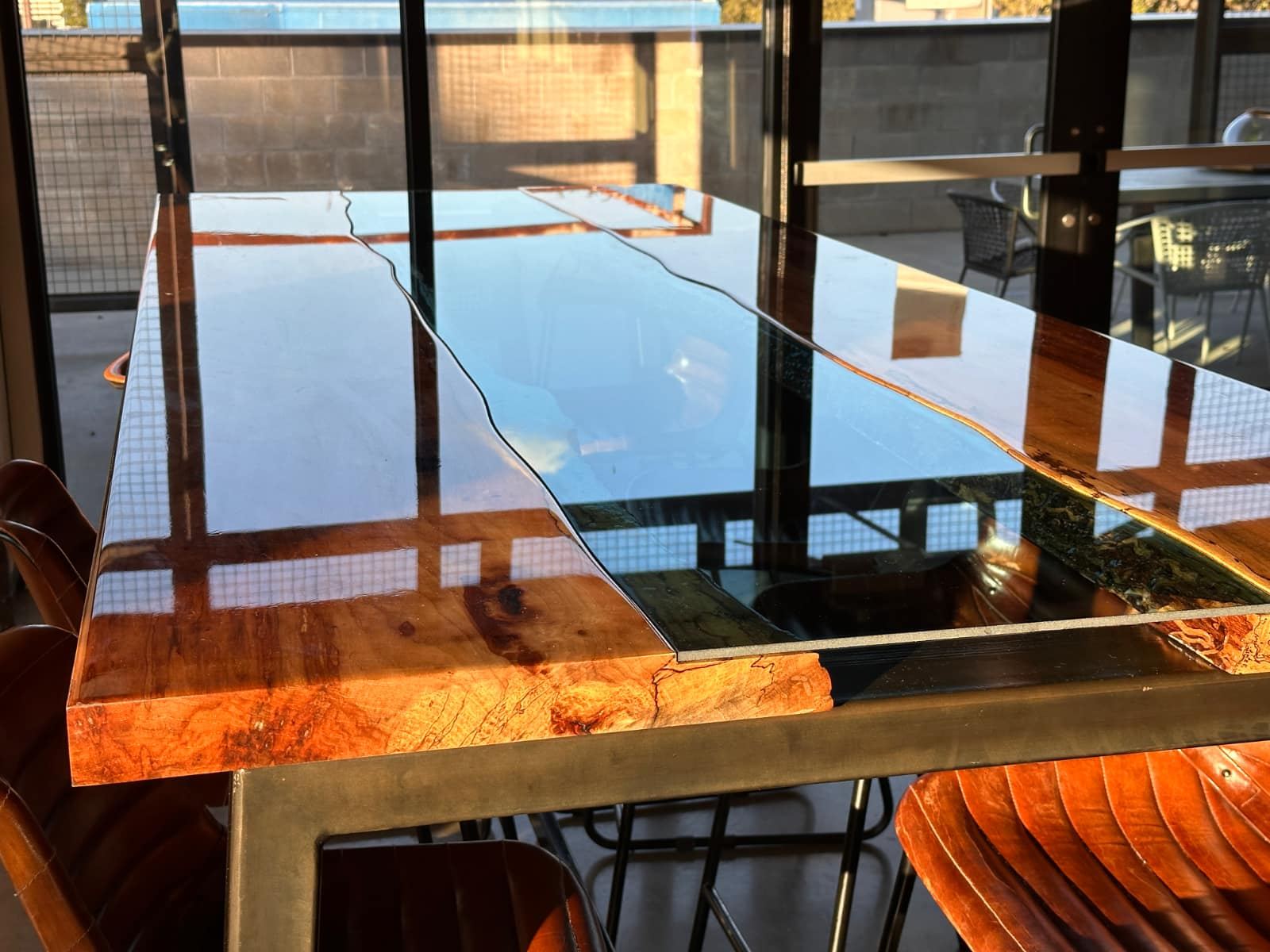 Live-edge wood table top with a glass center strip