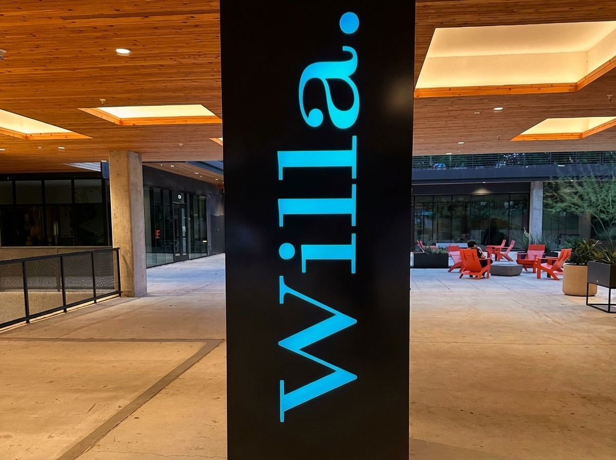 Black sign column at Willa with the name lit in blue push-through letters