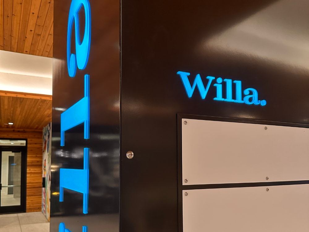 Close view of the column showing blue push-through letters and the directory panels